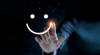 Digital Experience Finger of Businessman touching and drawing face emoticon